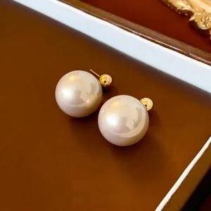 French style minimalist gold plated earrings with large cream pearls and rainbow sheen