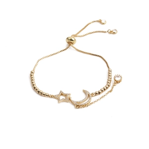Adjustable gold star and moon bracelet with sparkling cubic zirconia on a white background