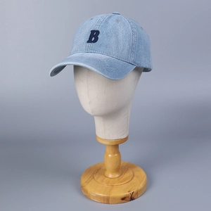 Classic light blue denim baseball cap with navy B letter embroidery on a display stand