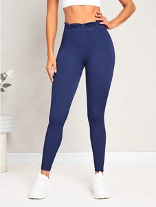 Detailed view of high-waist seamless yoga pants with ruching detail in dark blue