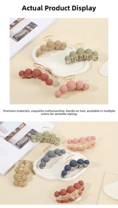 Detailed view of matte spherical hair claws in various elegant candy colors with springs
