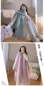 Close-up of thick pastel blue and purple long tassel scarves with soft cashmere-like texture