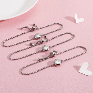 Detailed close-up of adjustable stainless steel zodiac bracelets with engraved charms
