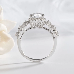 Macro view of silver halo ring featuring intricate heart-shaped cutout details