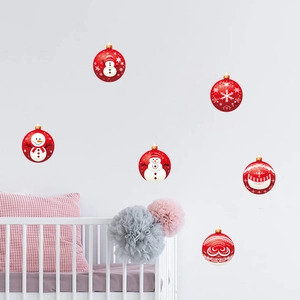 Red Christmas wall decals with snowmen and snowflakes above a white crib in a cozy room