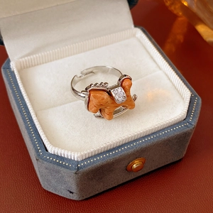 Detail of wooden rocking horse ring with zircon inlay on a velvet jewelry box
