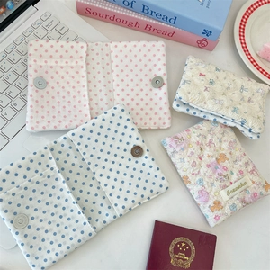 Quilted cotton passport holder with floral patterns and secure magnetic closure detail