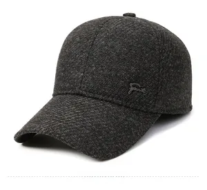 Detail of dark grey winter baseball cap with thick tweed texture and Sport metal logo