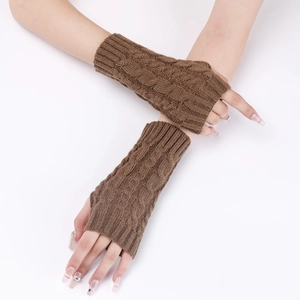 Detail of dark brown cable-knit arm warmers showing thick braided texture and fingerless design