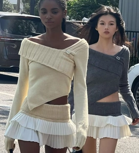 Detail of knitted pleated mini skirt with ruffled layers and a soft fabric texture