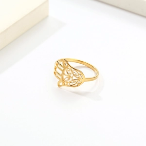 Golden Hamsa Hand ring in stainless steel with intricate hollow patterns on a white background
