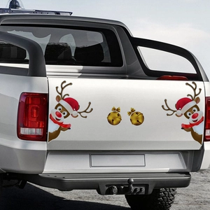 Reflective magnetic reindeer and bells decals on a white pickup truck tailgate for Christmas