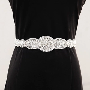 Detail of silver bridal waist chain with crystal flowers and leaves on a black dress