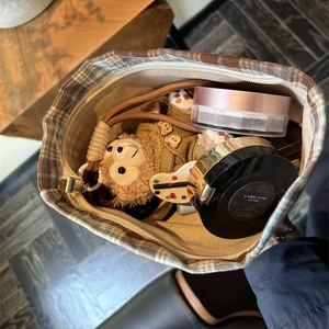 Internal view of brown checkered storage bag showing spacious capacity and lining