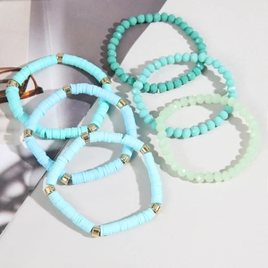 Detail view of 5-piece bohemian set featuring sky blue heishi beads and crystal bracelets