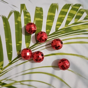 Macro shot of six red faceted UV plated metallic beads for DIY jewelry making crafts
