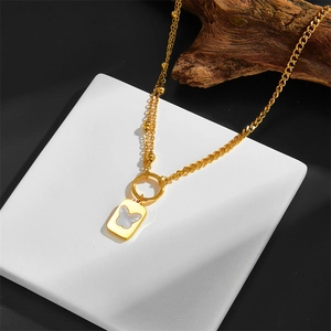 Detail of double-layer gold chain necklace with white shell butterfly square pendant