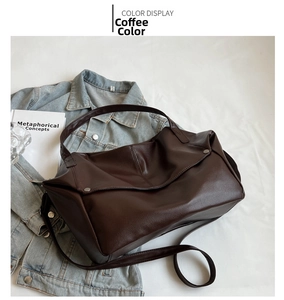 Detail view of coffee brown tote bag showing lychee grain leather and metal buckle hardware