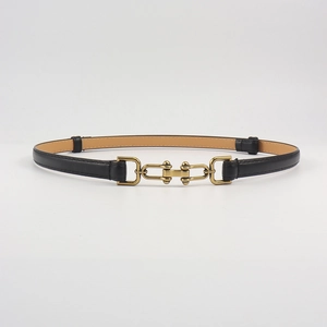 Detailed view of black leather belt featuring an antique bronze horsebit metal buckle