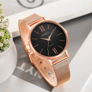 Detail of rose gold mesh watch with black textured dial and Roman numerals markers
