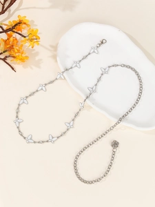 Detailed view of silver butterfly waist chain with white enamel and rhinestones on tray