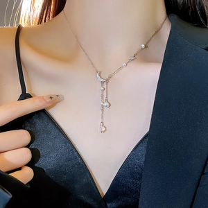 Elegant moon pendant necklace with long tassel and pearls on a silver titanium steel chain