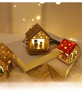 Detail of wooden Christmas house with LED light and hollow star pattern hanging by jute rope