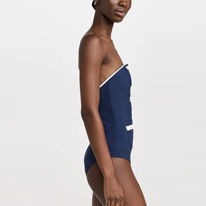Detail of navy tube top swimsuit featuring white buttons and nautical trim accents