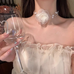 Detailed view of an elegant white mesh rose choker necklace with faux pearl chain