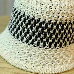 Close-up of the detailed black and white woven texture on a summer sun bucket hat