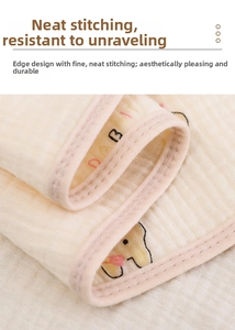 Detail of neatly stitched hem on soft cotton gauze baby hooded towel with rabbit print