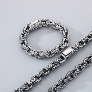 Close-up of vintage hammered texture stainless steel chain bracelet and necklace set