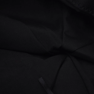 Detailed close-up of the fine black woven fabric texture on a stylish PU beret hat