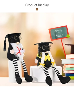 Detail view of graduation gnomes with black caps, glasses, and Knowledge is Power blackboard