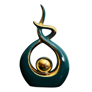 Modern abstract sculpture with deep teal waves and a gold orb on white background