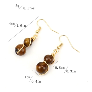 Detail view of handmade gold wire-wrapped earrings featuring tiger eye beads and dimensions