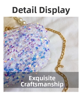 Detail of shimmering sequin shell bag with golden metal chain and pearl handle