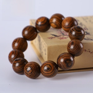 Macro shot of 20mm Tiger Wood beads showing natural texture on vintage background
