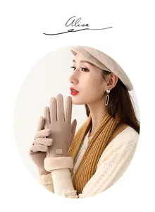 Detail of warm winter gloves for women with faux fur cuff and fashion fabric label