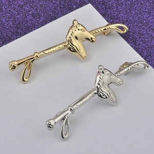 Detailed view of horse head nipple rings in gold and silver finish with spiral bars