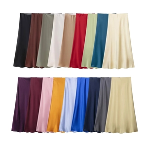 Close-up of smooth satin midi skirts in a wide variety of colors on white background
