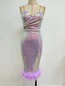 Detailed view of iridescent purple sequins and luxury ostrich feathers on the dress hem