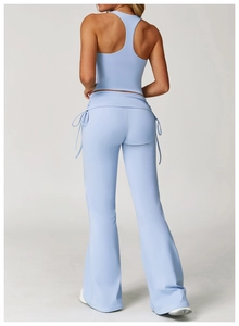 Detail of light blue racerback yoga tank top and flared leggings with drawstring waist
