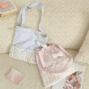 Detail of sweet bow striped tote bags with drawstring closure and floral lining