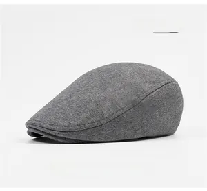 Side view detail of a dark grey cotton flat cap showing high quality stitching and texture