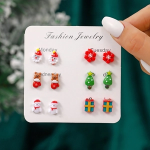 Detailed view of six pairs of Christmas earrings including Santa Claus and Snowman on a card