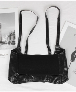 Detailed view of a black PU leather corset belt with elastic mesh on white texture