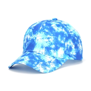 Detail of blue and white tie-dye cotton baseball cap with curved brim and 6-panel crown