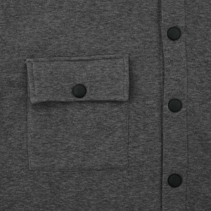 Detail of dark grey knit fabric with cargo flap pocket and matte black snap buttons