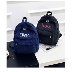 Customized corduroy backpacks in navy and black featuring personalized name embroidery